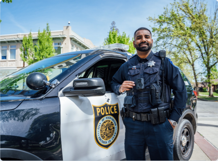 Office in front of police car